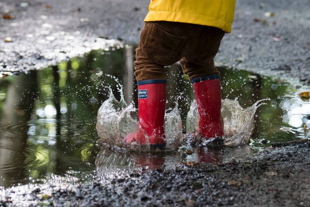 Child plashing in puddles